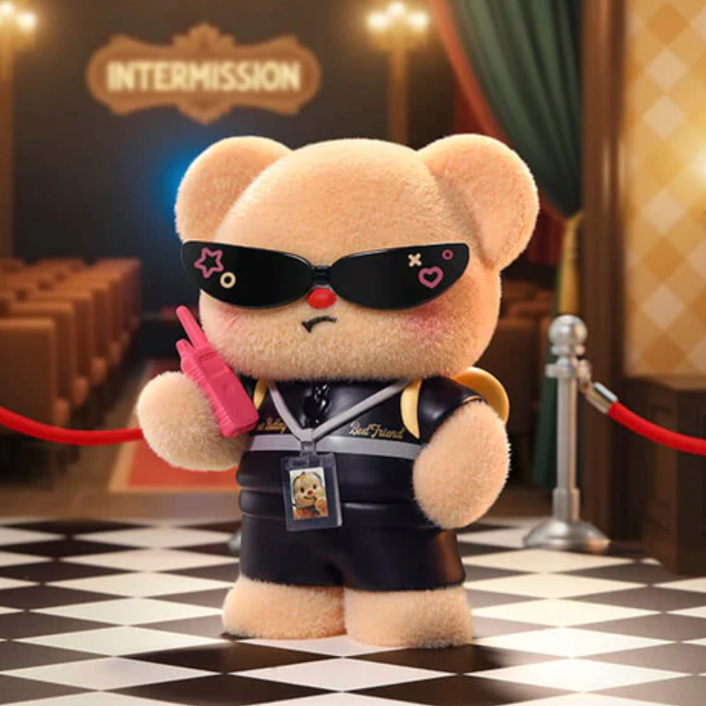 Teddy bear with sunglasses and a pink gun in a theater setting