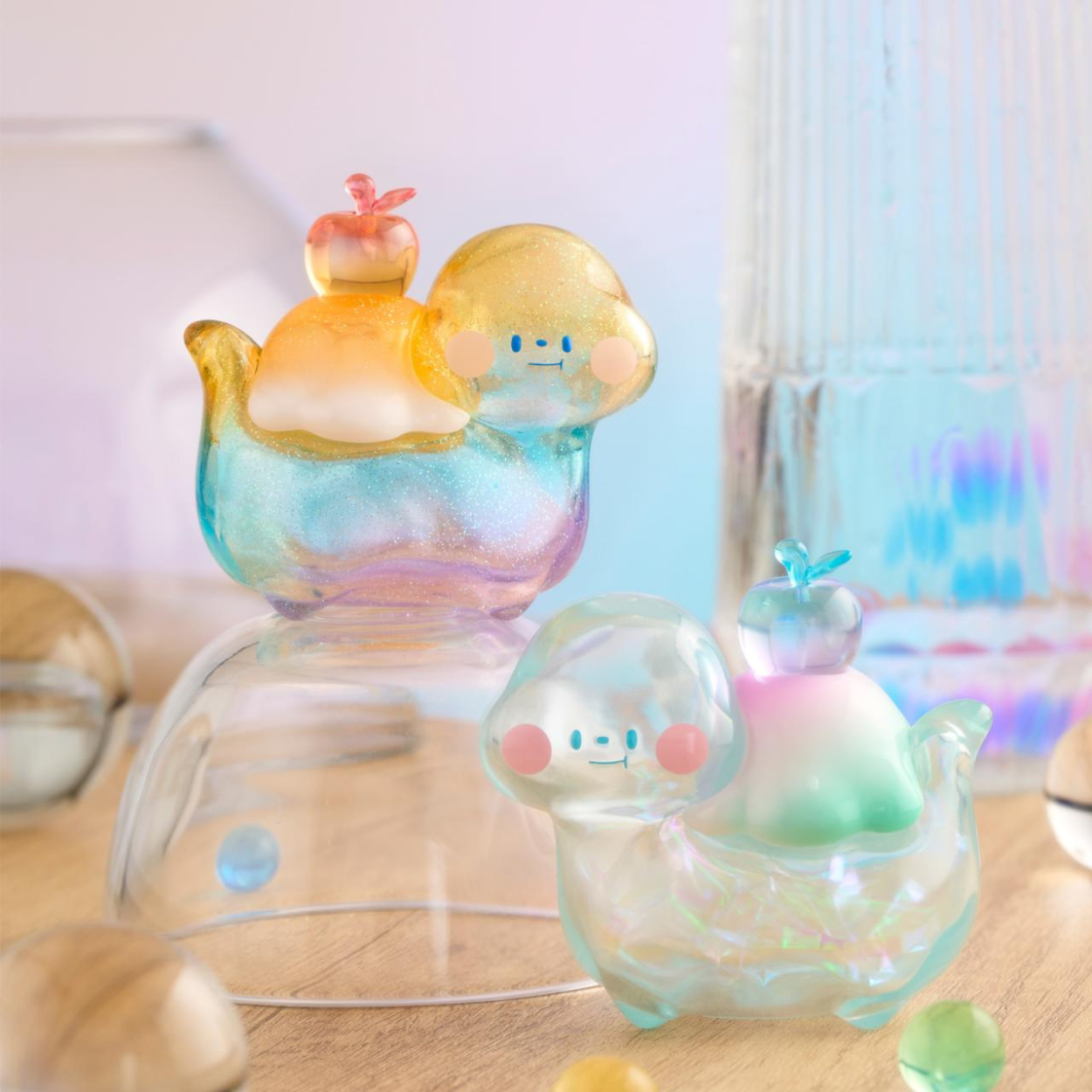 Colorful glass figurines on a wooden surface with a blurred background