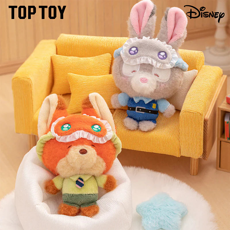 Two plush toys, one orange and one gray with pink ears, on a yellow couch with 'Top Toy' and 'Disney' branding.