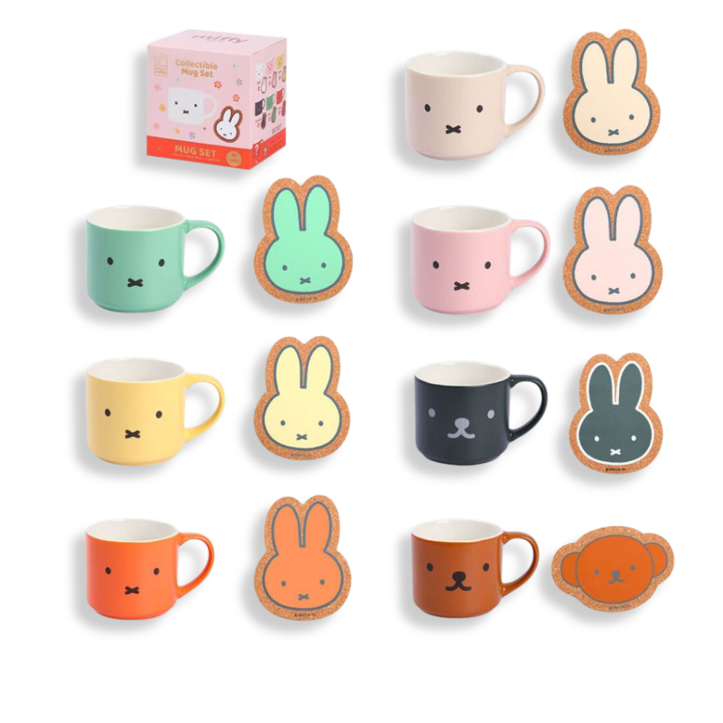 Set of colorful mugs and matching rabbit-shaped cookies on a white background