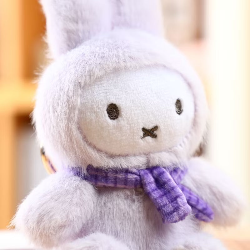White plush toy with a purple scarf on a blurred background