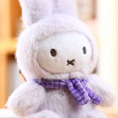 White plush toy with a purple scarf on a blurred background