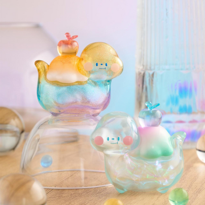 Colorful glass figurines on a wooden surface with a blurred background